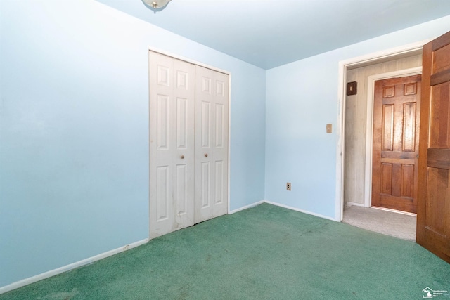 unfurnished bedroom with dark colored carpet and a closet