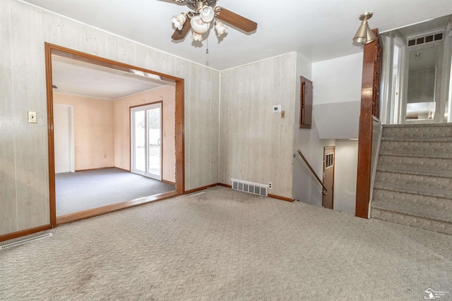 carpeted spare room with electric panel and ceiling fan