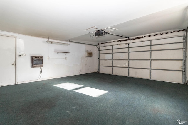 garage featuring heating unit and a garage door opener