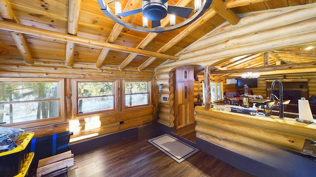 interior space featuring lofted ceiling with beams, wooden ceiling, arched walkways, log walls, and dark wood-style flooring