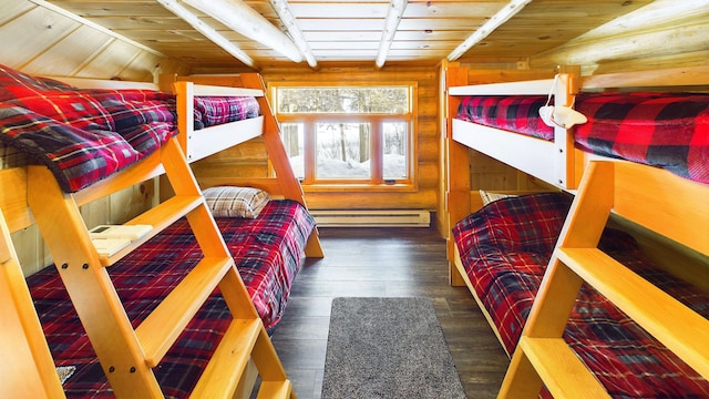 bedroom featuring beamed ceiling, a baseboard heating unit, wood finished floors, wooden walls, and wood ceiling