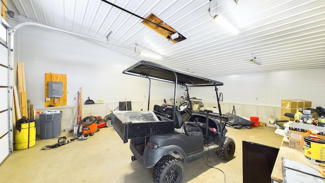 garage with electric panel and a garage door opener