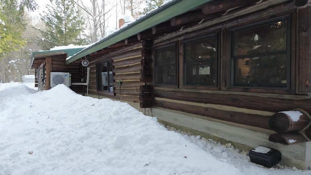 view of snow covered exterior with ac unit