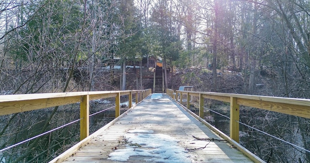 dock area with a forest view and stairway