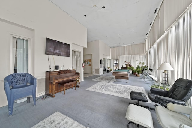 living room with a high ceiling, carpet flooring, and billiards