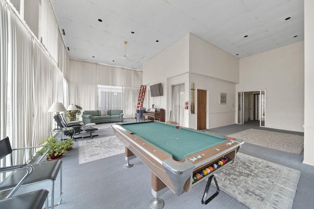 playroom with pool table, carpet, and a high ceiling