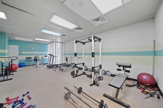 exercise room featuring a drop ceiling