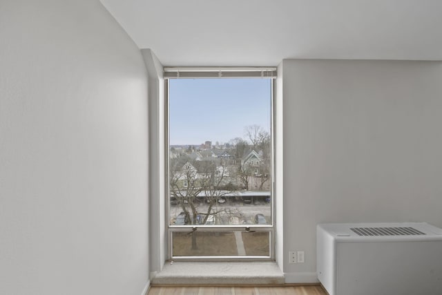 interior space featuring expansive windows and light hardwood / wood-style flooring