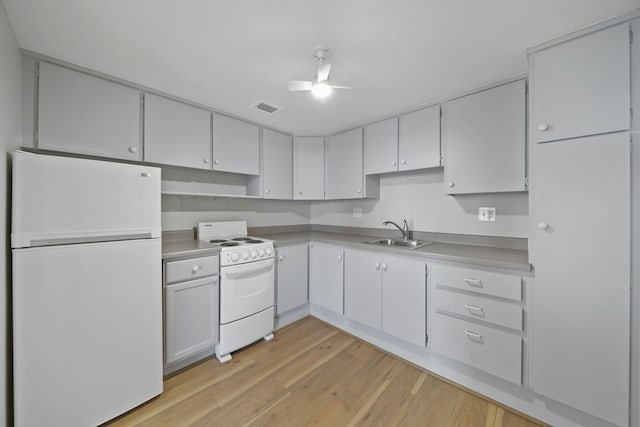 kitchen featuring white cabinetry, sink, ceiling fan, white appliances, and light hardwood / wood-style flooring