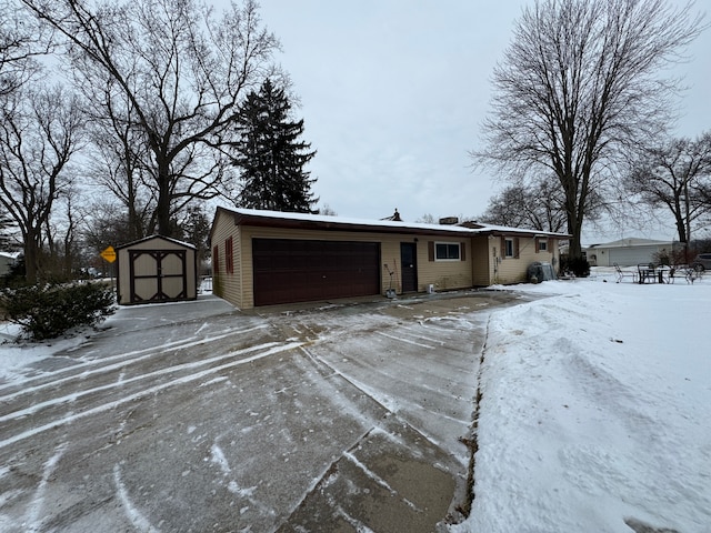 view of front of property with a garage and a storage unit