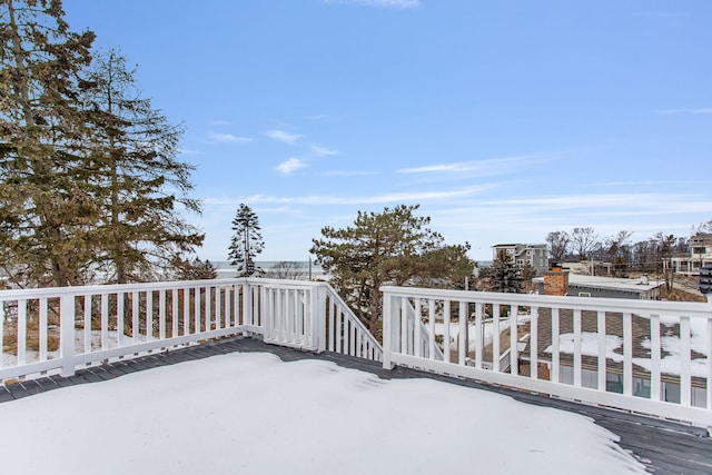 snow covered patio with a deck