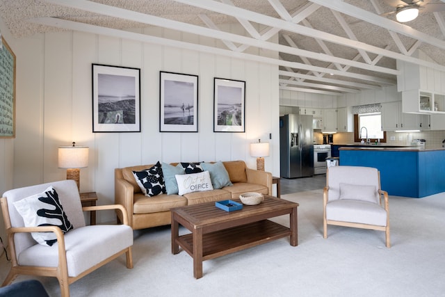 living room featuring sink and vaulted ceiling