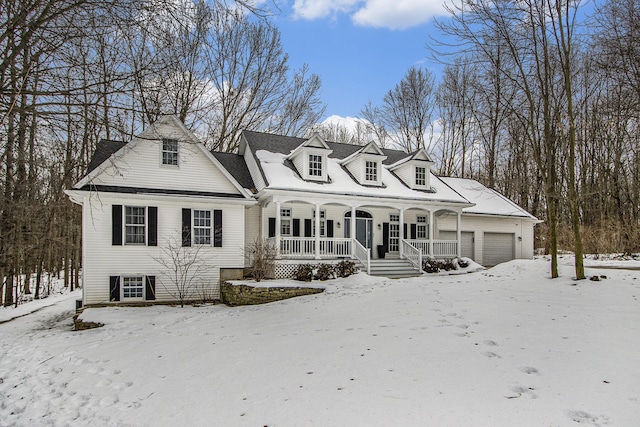 cape cod house with a garage and covered porch