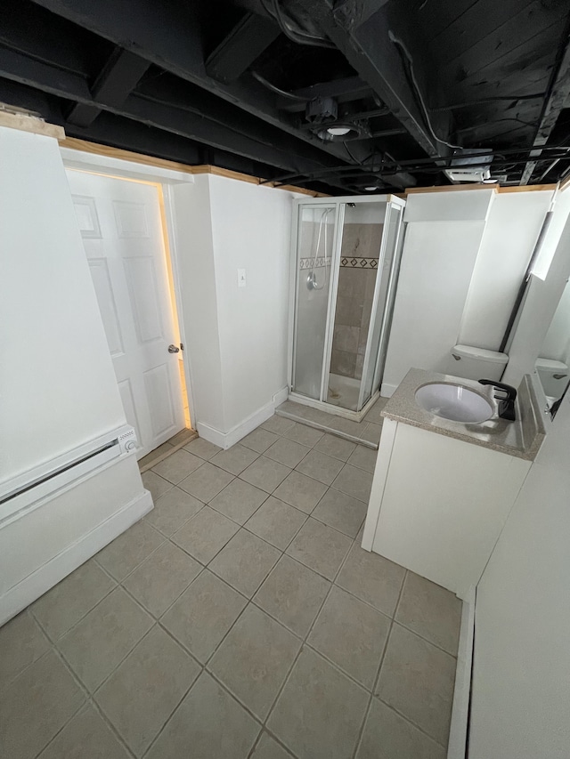 bathroom featuring tile patterned flooring, vanity, and a shower with door