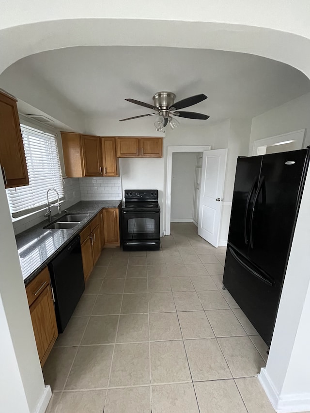 kitchen with sink, light tile patterned floors, ceiling fan, decorative backsplash, and black appliances