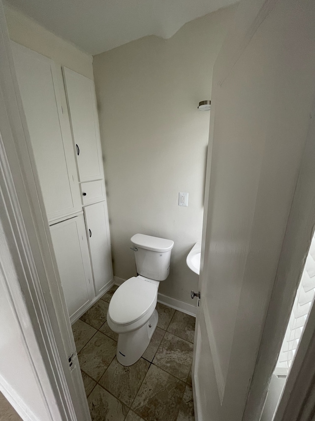 bathroom with tile patterned flooring and toilet