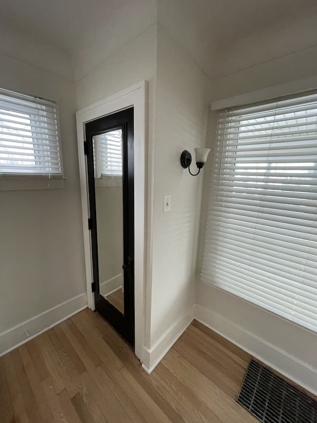 hall with light hardwood / wood-style floors