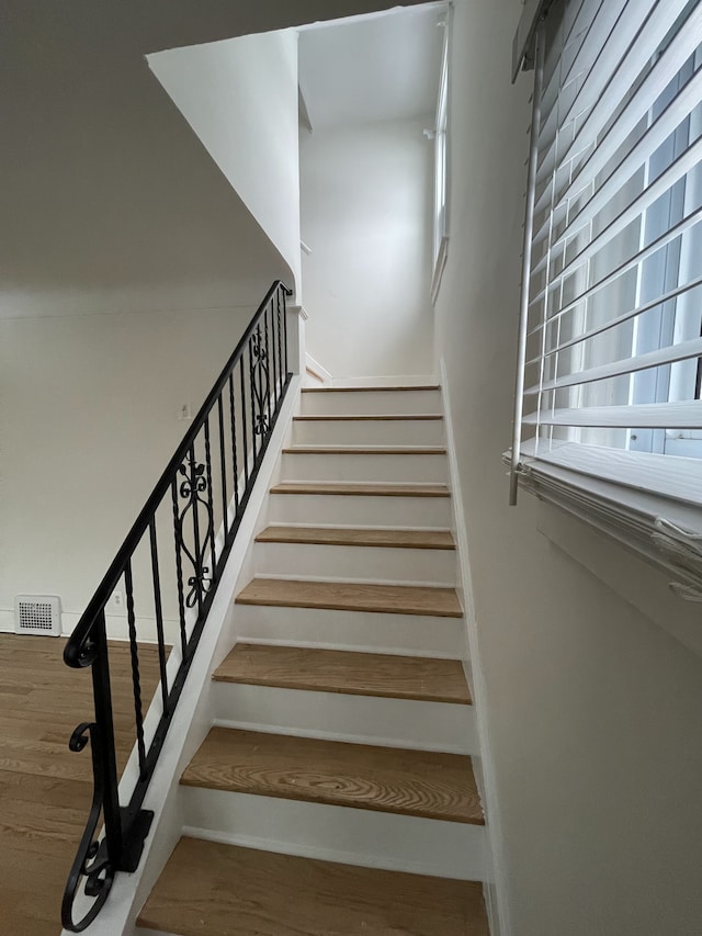 staircase featuring wood-type flooring