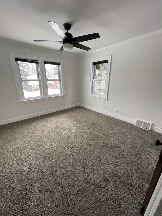 unfurnished room featuring crown molding, carpet, and ceiling fan