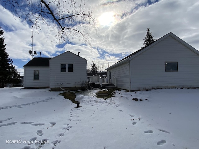 snow covered property with a deck