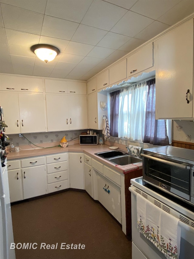 kitchen featuring white cabinetry and sink