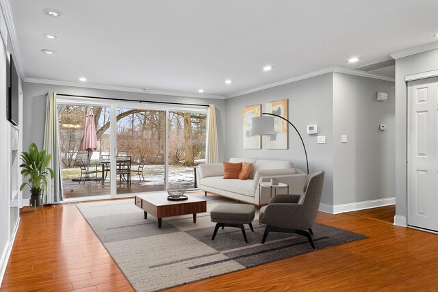 living room with hardwood / wood-style flooring and ornamental molding