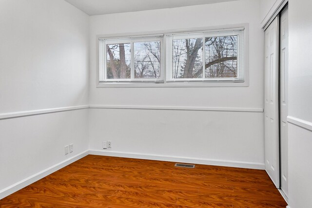 spare room with hardwood / wood-style flooring