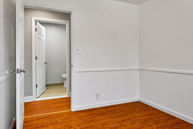 unfurnished room with wood-type flooring