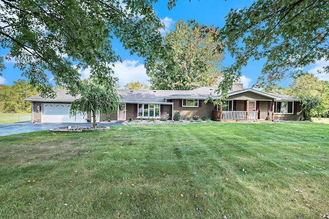 ranch-style house featuring a chimney, aphalt driveway, an attached garage, covered porch, and a front lawn