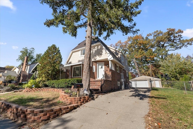 view of front facade with a garage, an outdoor structure, and a front yard