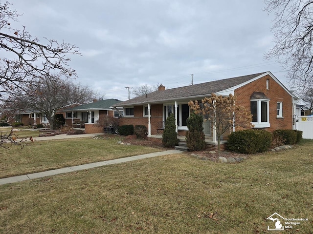 ranch-style home with a front lawn