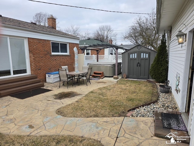 view of yard featuring a storage unit, a hot tub, and a patio