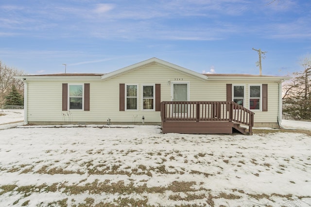 snow covered property featuring a deck