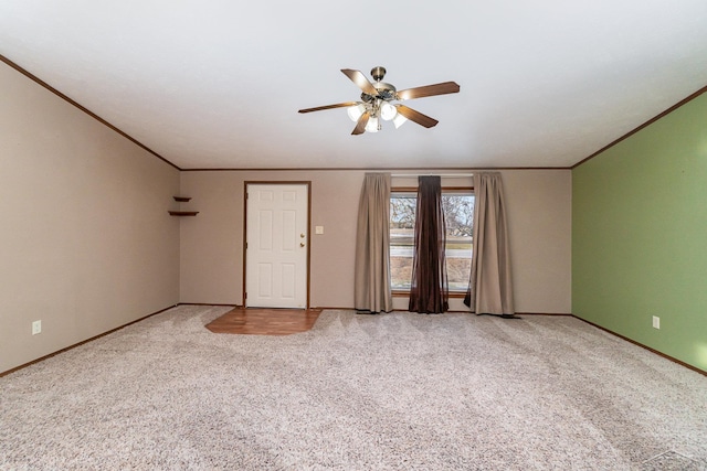 carpeted spare room with ornamental molding and ceiling fan