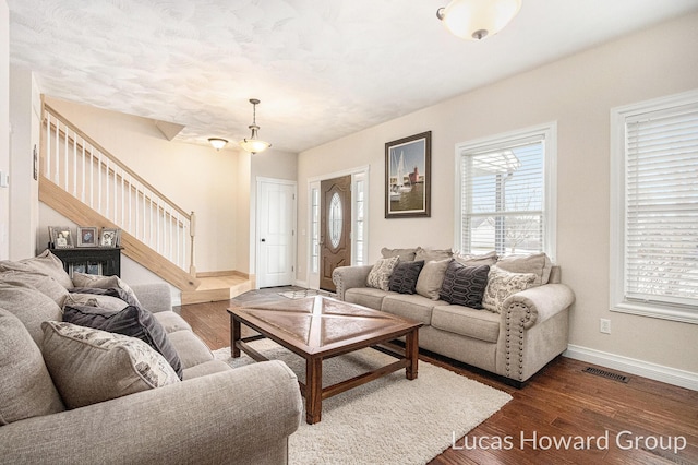 living room featuring dark wood-type flooring