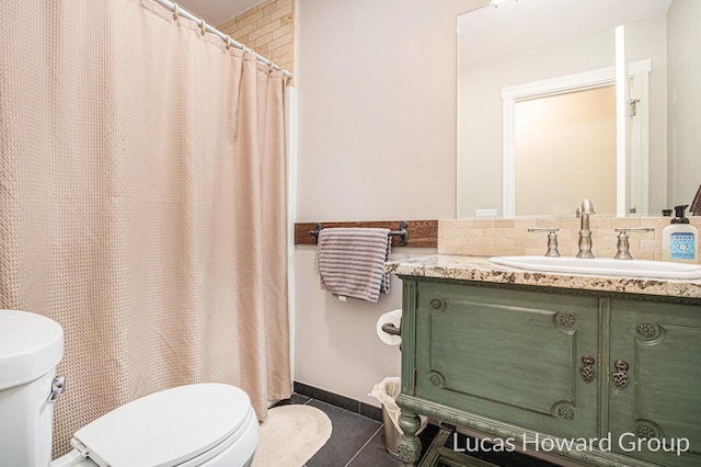 bathroom with tile patterned floors, toilet, and vanity