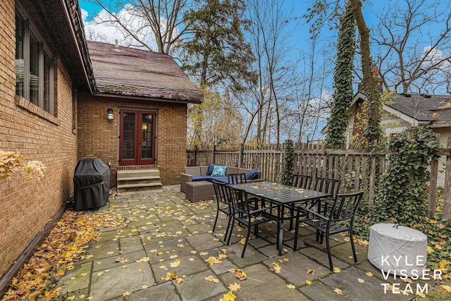 view of patio with entry steps, grilling area, fence, and an outdoor living space