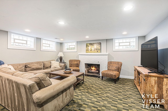 living room featuring recessed lighting, baseboards, a fireplace, and dark colored carpet