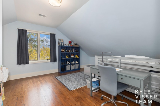 office space with lofted ceiling, dark wood-type flooring, visible vents, and baseboards