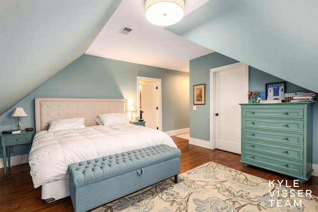 bedroom with dark wood-style floors, lofted ceiling, visible vents, and baseboards