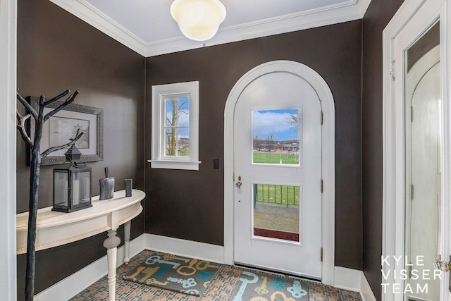 entrance foyer with baseboards and ornamental molding