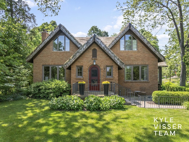 2346 Lake Dr SE, East Grand Rapids, MI 49506 - tudor home featuring a chimney and brick siding