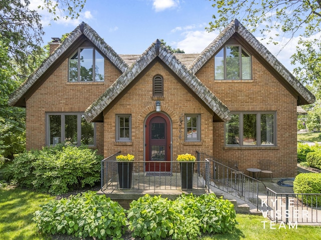 2346 Lake Dr SE, East Grand Rapids, MI 49506 - tudor-style house featuring a chimney and brick siding