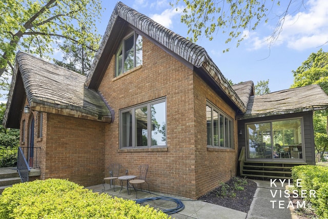 2346 Lake Dr SE, East Grand Rapids, MI 49506 - view of home's exterior with brick siding and a patio area