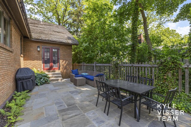 2346 Lake Dr SE, East Grand Rapids, MI 49506 - view of patio / terrace with french doors, area for grilling, entry steps, outdoor dining area, and an outdoor hangout area