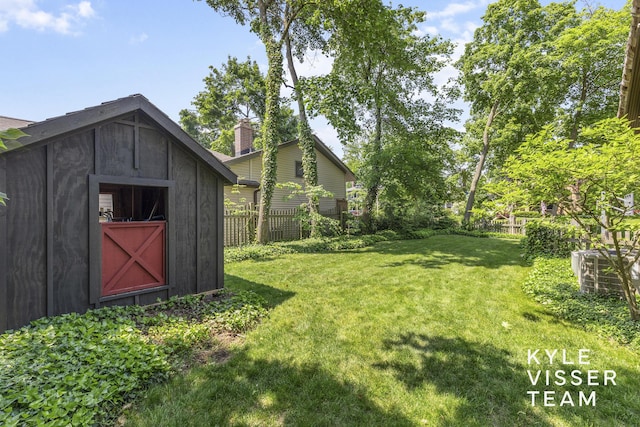 2346 Lake Dr SE, East Grand Rapids, MI 49506 - fenced backyard featuring a storage unit