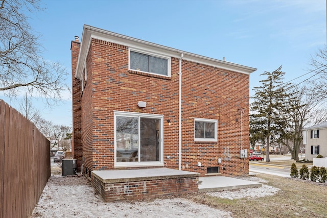 rear view of property with a patio area and central air condition unit