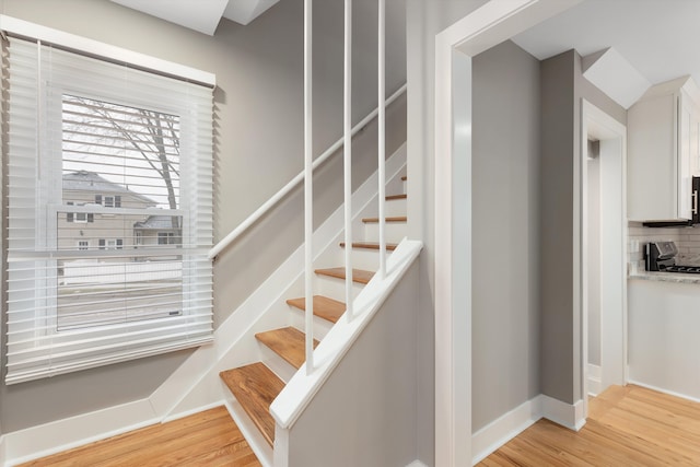 stairs with hardwood / wood-style floors