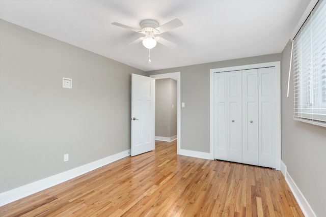 unfurnished bedroom with ceiling fan, a closet, and light wood-type flooring