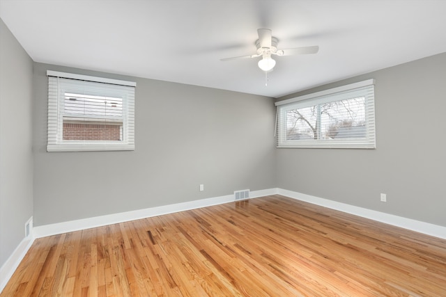 empty room featuring hardwood / wood-style floors and ceiling fan